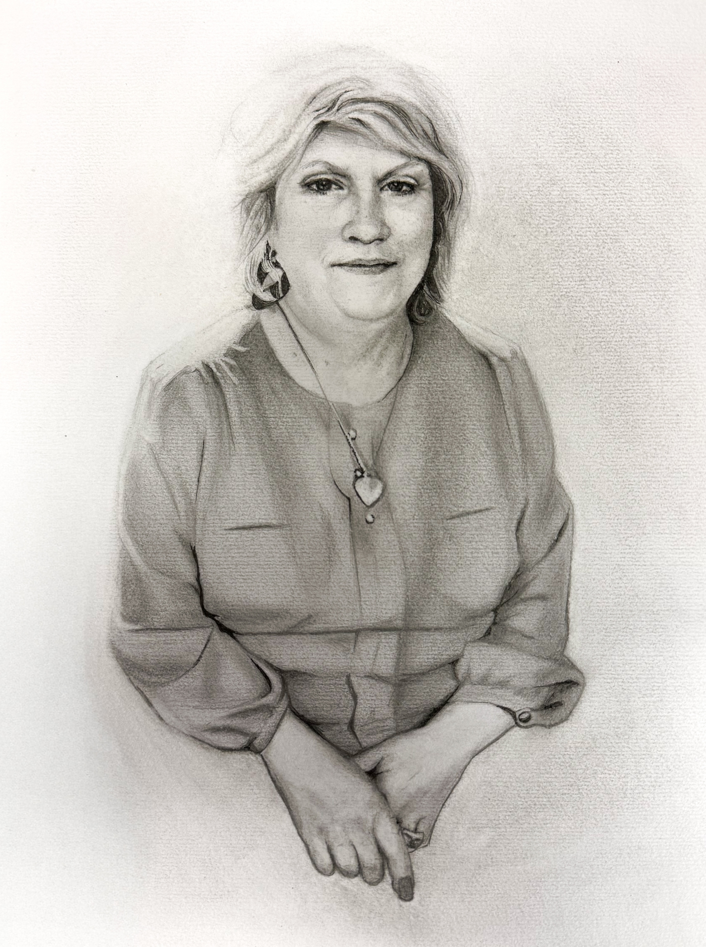 Daniel's mom — seated woman with heart pendant